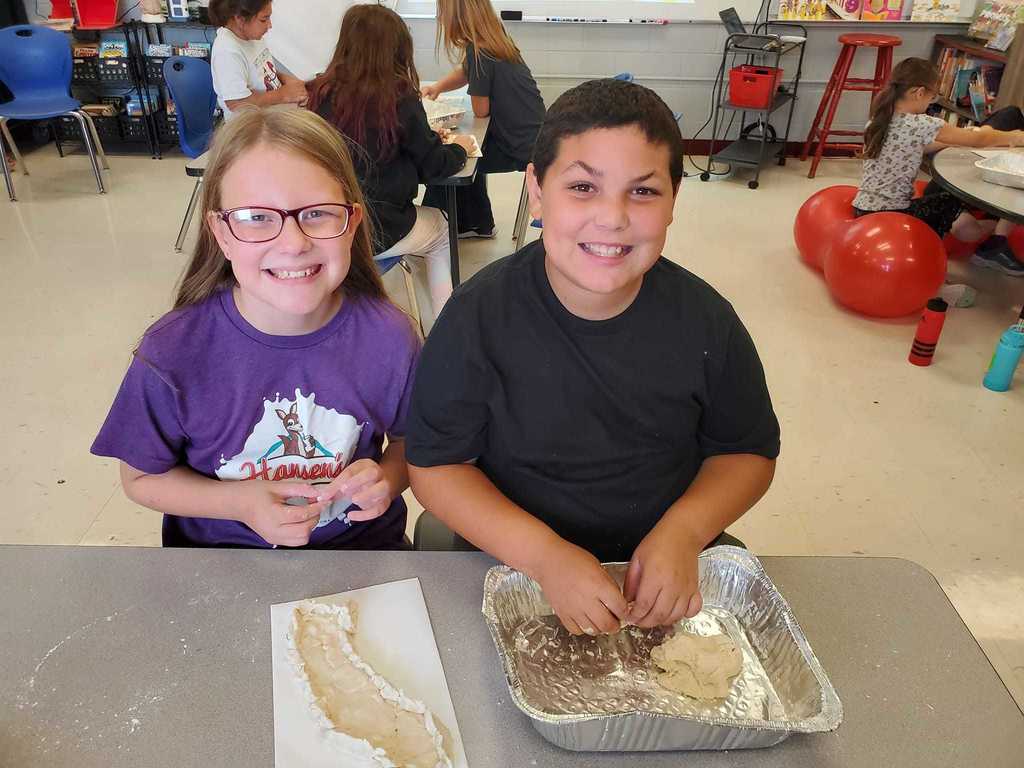 Whittier students making models of California using dough